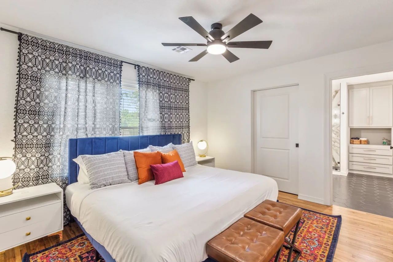 King bedroom with colorful accents at Trendy in Tulsa